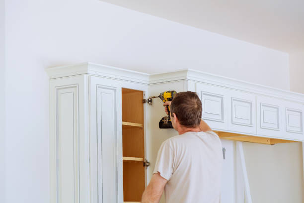 technician man installing kitchen cabinets Installation of kitchen cabinet. Cabinet Installation & Refacing